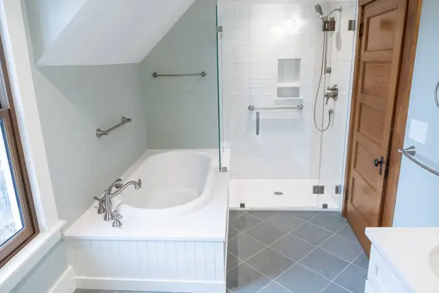 Bathroom remodel with soaking tub and beadboard apron, frameless glass shower, grab bars and slate-look tile floor
